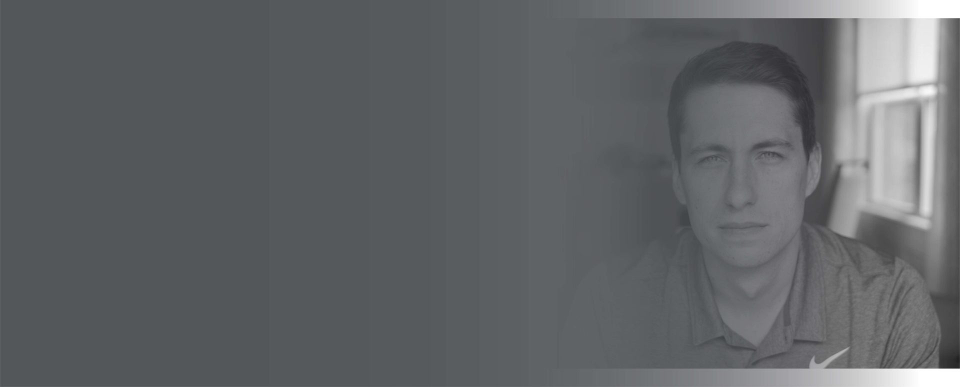 Headshot of Nick Huber, smiling in a collared shirt and tie with an orange microphone to the left of the image