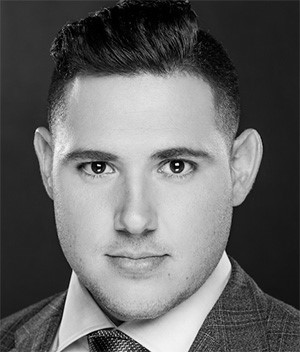 Headshot of Scott O'Neil, smiling in a collared shirt and tie with an orange microphone to the left of the image