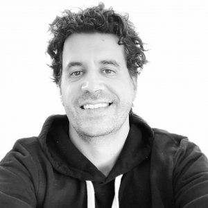 Headshot of Sean Sweeney in a black hoodie