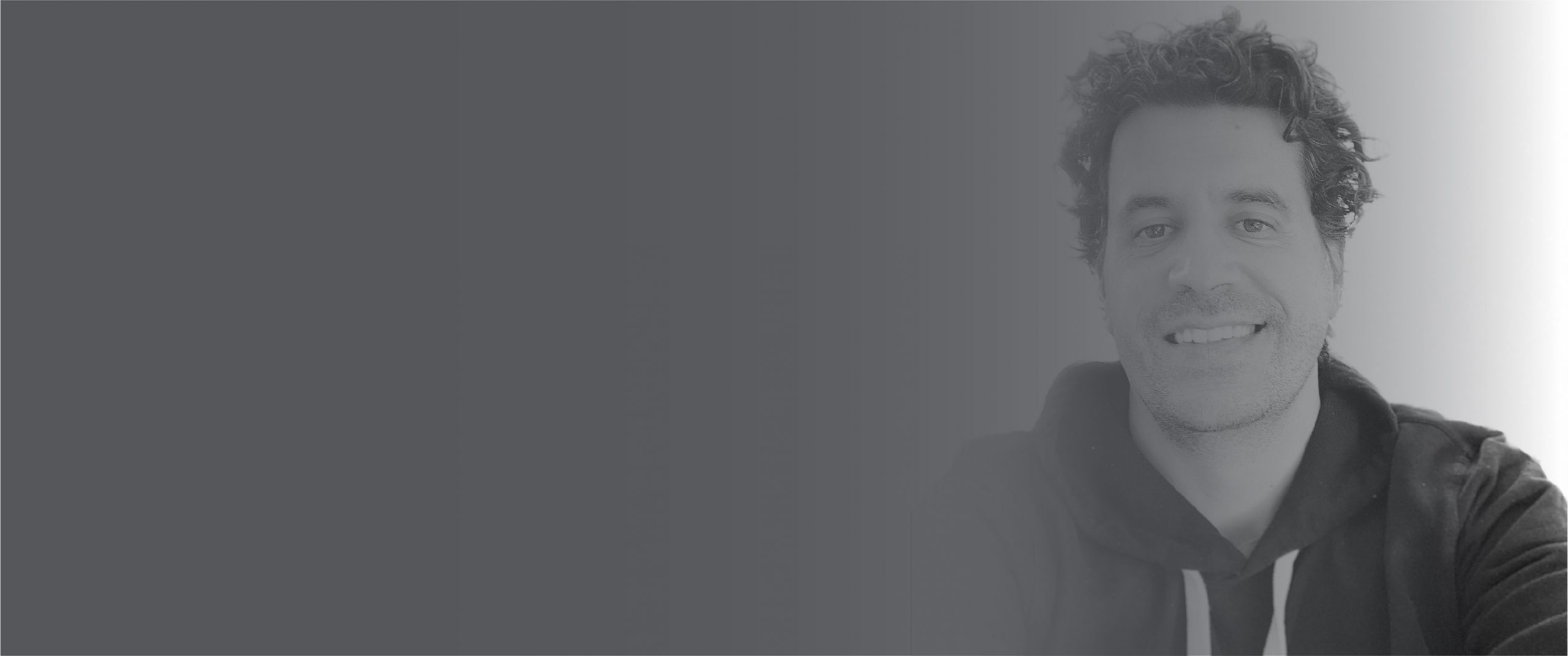 Headshot of Sean Sweeney in a black hoodie